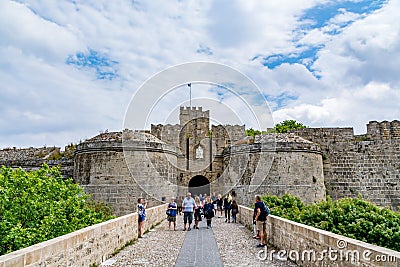 Ambrose Gate and bridge leading to it in Rhodes old town with tourists Editorial Stock Photo